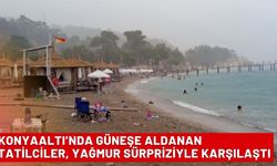 Konyaaltı’nda güneşe aldanan tatilciler, yağmur sürpriziyle karşılaştı