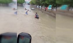 Biriken sel sularında yüzen çocukların tehlikeli eğlencesi kamerada