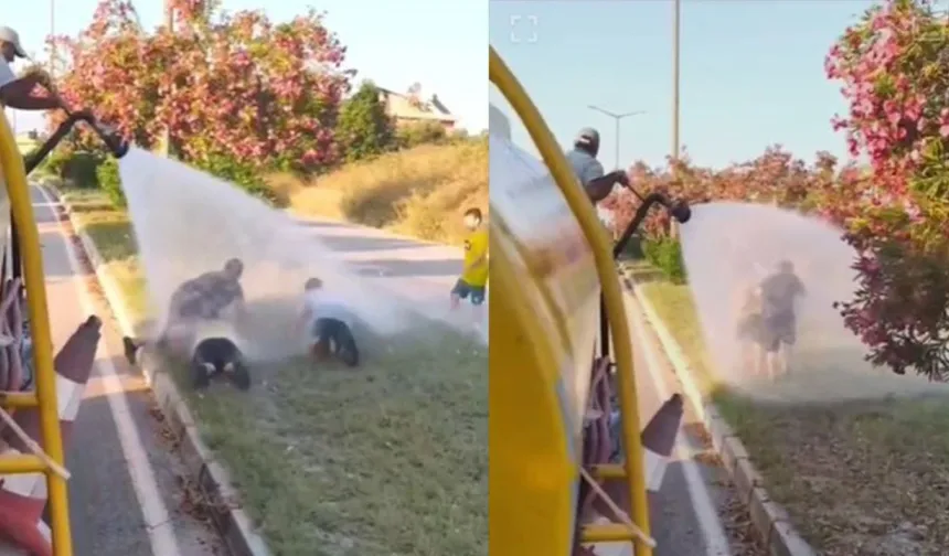 Sıcaktan bunalan çocuklar refüjde sulama yapan su tankeriyle serinledi